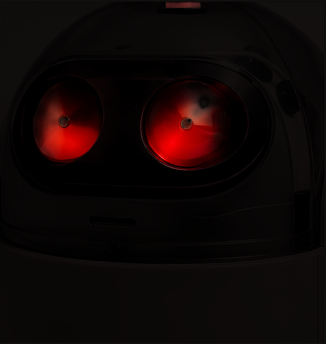 A R.O.V.E.R. unit in the dark, only its two red eyes lit